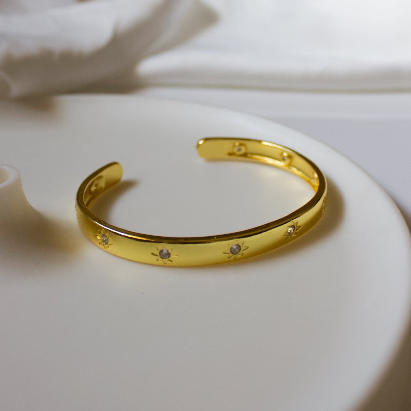 Gold bracelet with embedded stones.